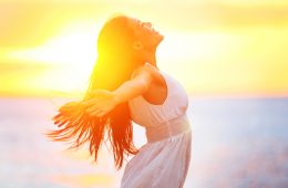 Enjoyment – free happy woman enjoying sunset